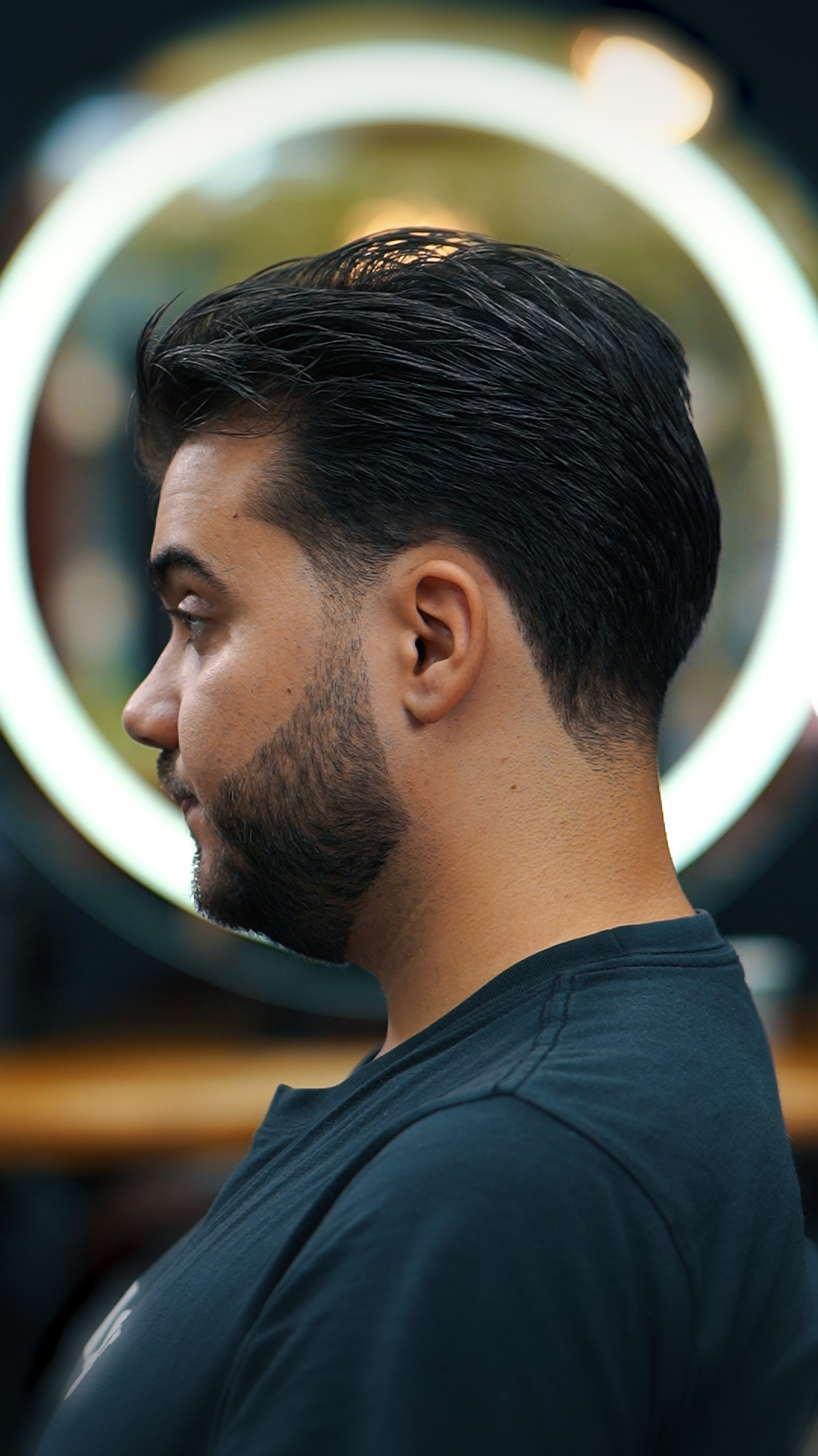 Men's textured taper haircut and beard shape at Empire Barbershop Amsterdam West